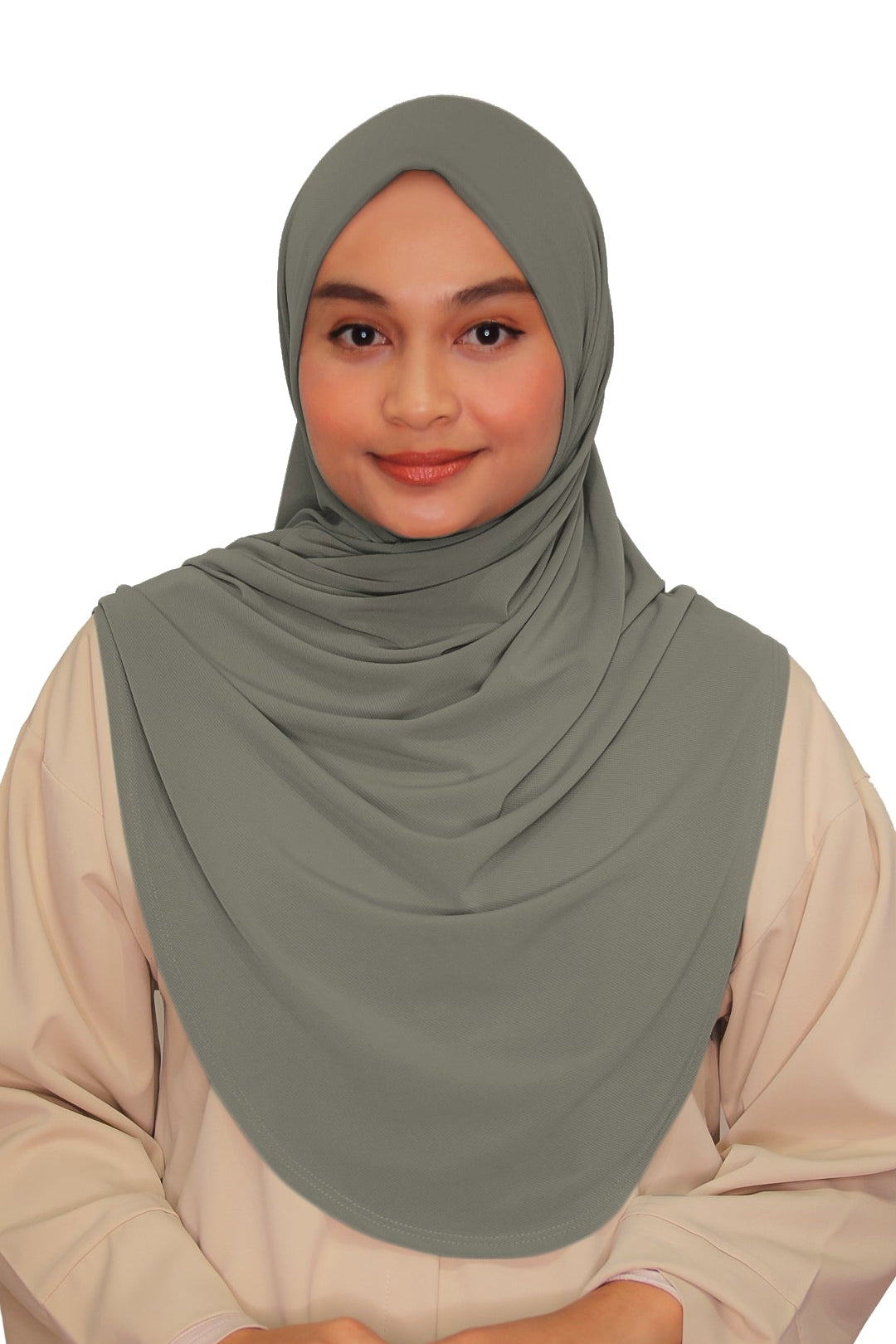 Woman wearing a green hijab and beige outfit on a white background