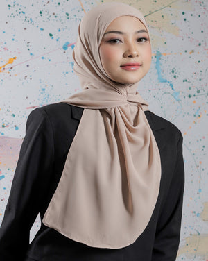 Woman wearing a beige hijab against a colorful abstract background